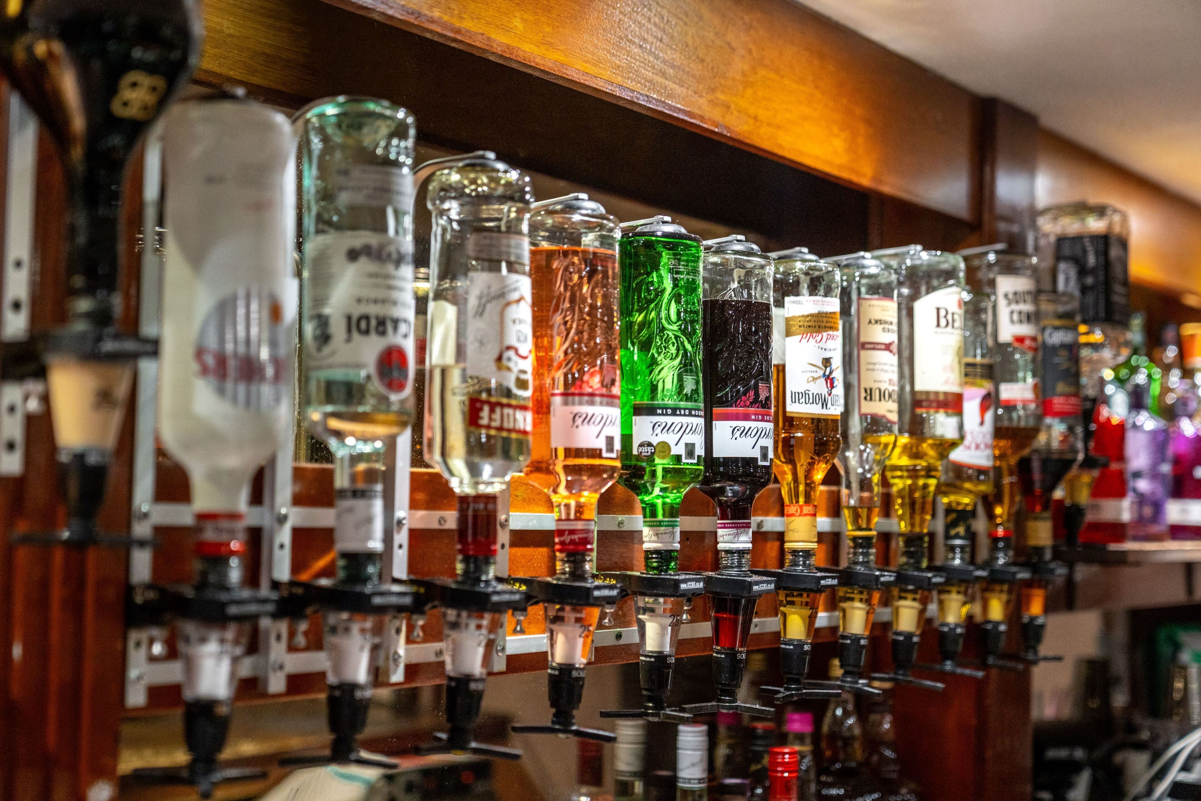 A bar with multiple liquor dispensers.