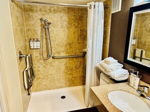 A bathroom with a bathtub, shower, and sink.