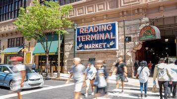 A street scene with a prominent sign for Reading Terminal Market.