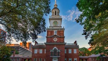 A historic building with a prominent clock tower, large windows, and a central entrance.