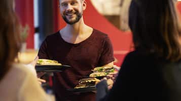 A person serving food to guests.