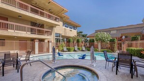 A hotel with a pool area, outdoor seating, and a multi-story building with balconies. - Best Western Plus Inn of Hayward (Hayward)