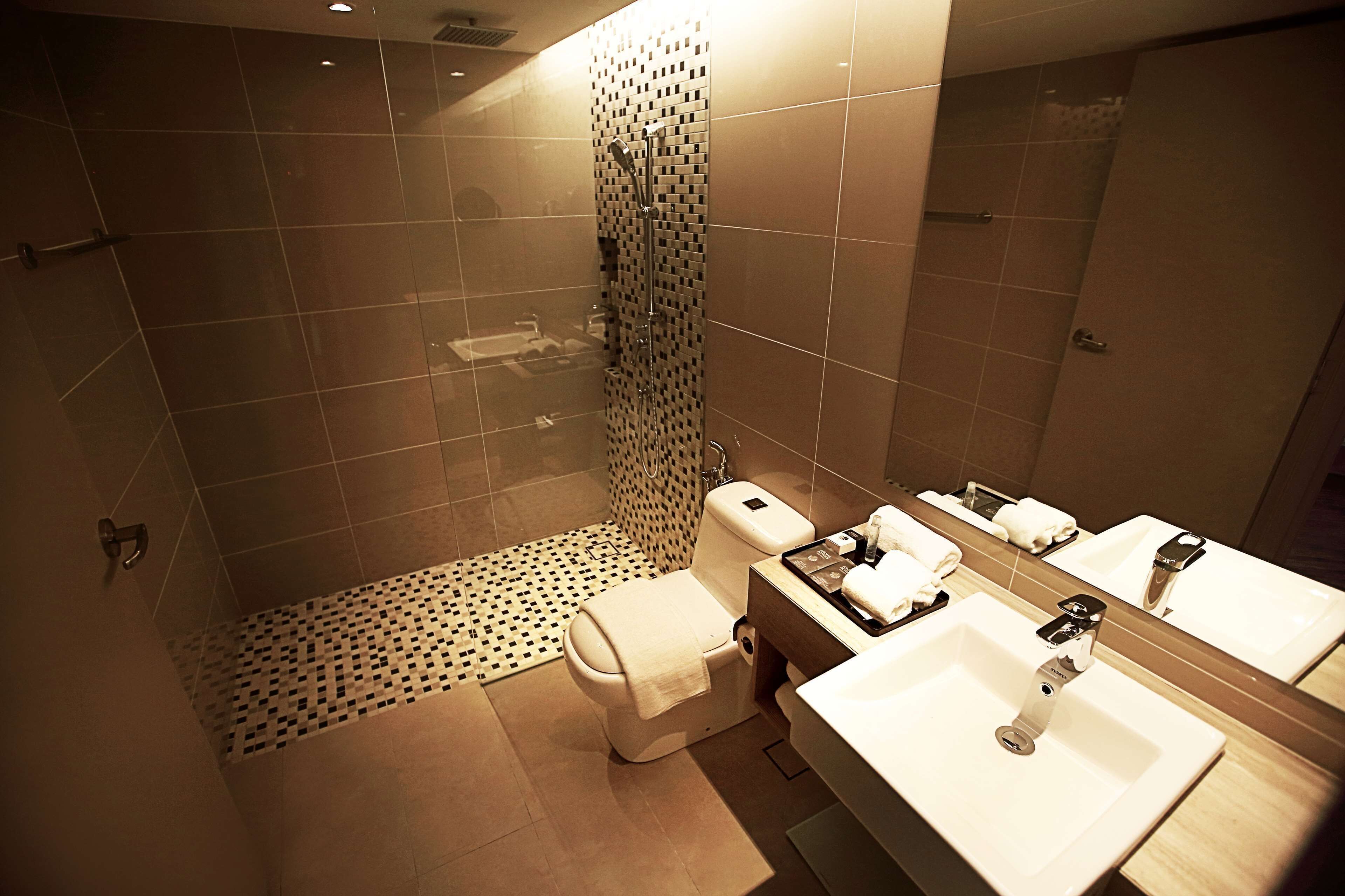 Un baño moderno con ducha, inodoro y lavabo.