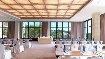 A conference room with tables, chairs, and a sofa.