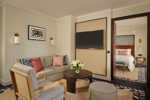 A hotel room with a sofa, armchair, coffee table, and a TV on the wall. - Castillo Hotel Son Vida, a Luxury Collection Hotel, Mallorca (Palma de Mallorca)