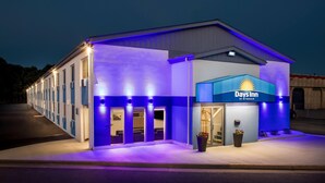 A Days Inn hotel with a modern facade, large windows, and a well-lit entrance. - Days Inn by Wyndham La Crosse (La Crosse)