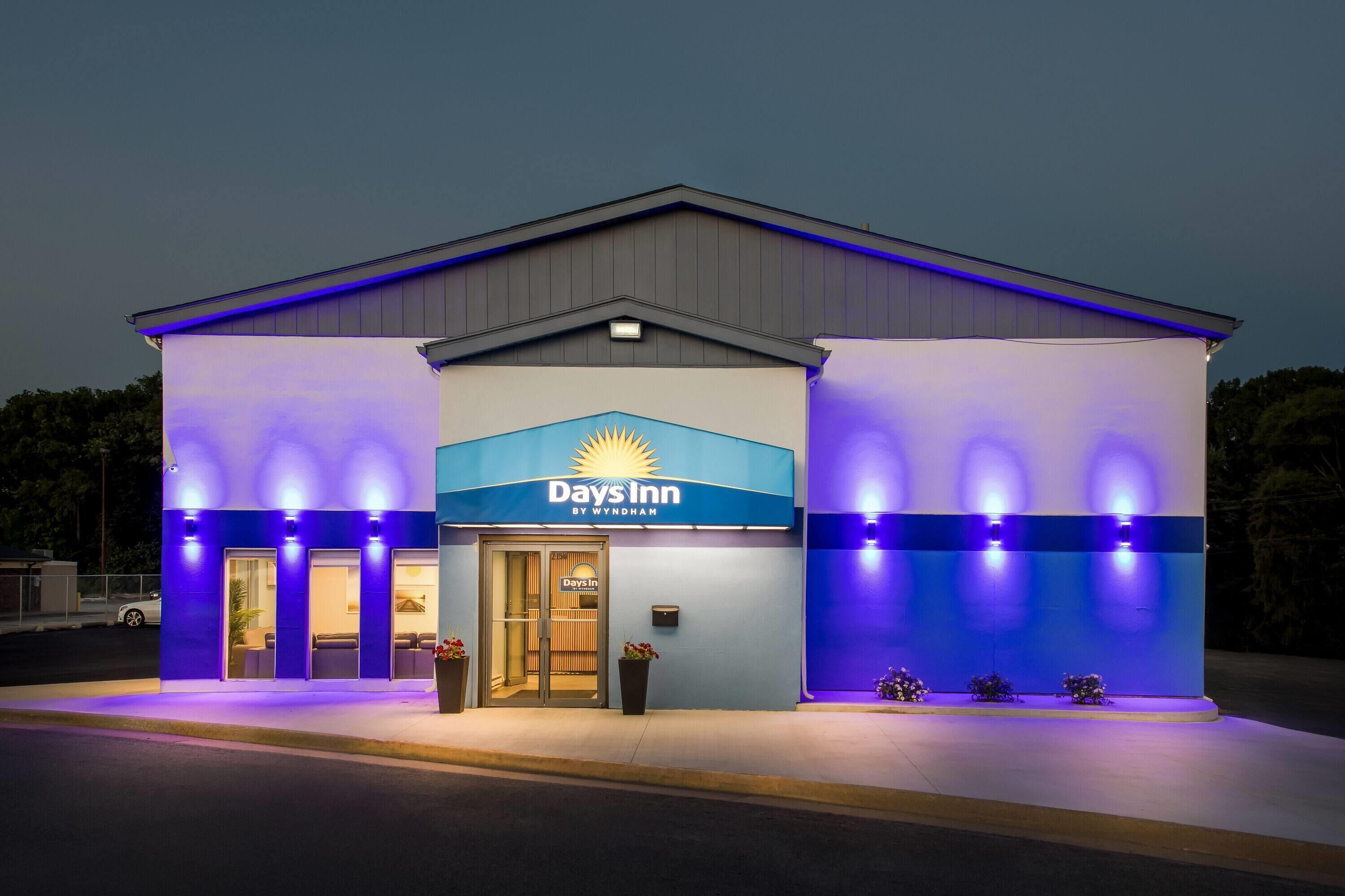 A Days Inn by Wyndham building with a sign, entrance, and exterior lighting.