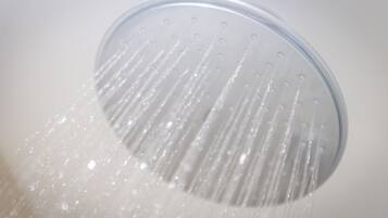 A showerhead with water flowing from it.