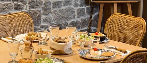 A restaurant table set with various dishes, glasses, and cutlery.
