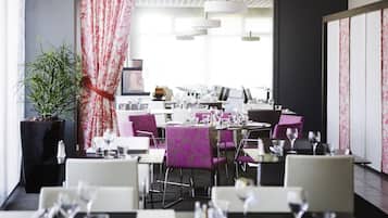 A modern restaurant with purple upholstered chairs, white tables, and a large potted plant.