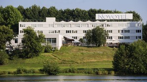 A modern hotel with a flat roof, multiple windows, and a sign reading "NOVOTEL". - Novotel Limoges Le Lac (Limoges)
