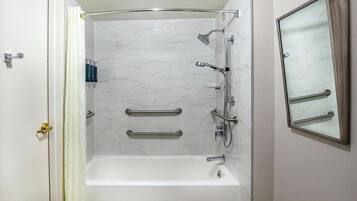 Bathtub, designer toiletries, hair dryer, towels
