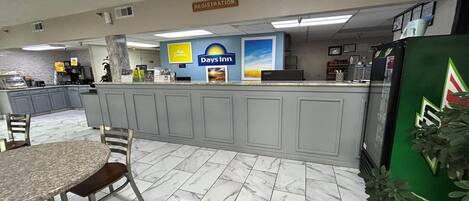 Ein Hotel-Registrierungsbereich mit marmorbodenbelagtem Boden, einer Rezeption und einem Schild für Days Inn.