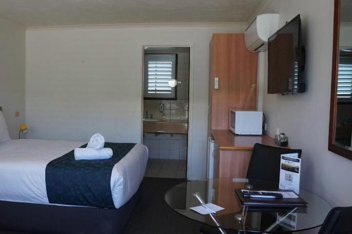 Desk, laptop workspace, blackout drapes, iron/ironing board