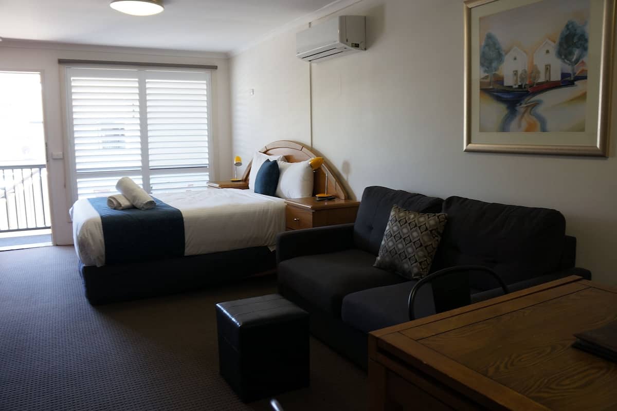 queen twin suite | desk, laptop workspace, blackout curtains, iron/ironing board