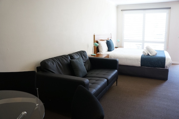 Desk, laptop workspace, blackout curtains, iron/ironing board