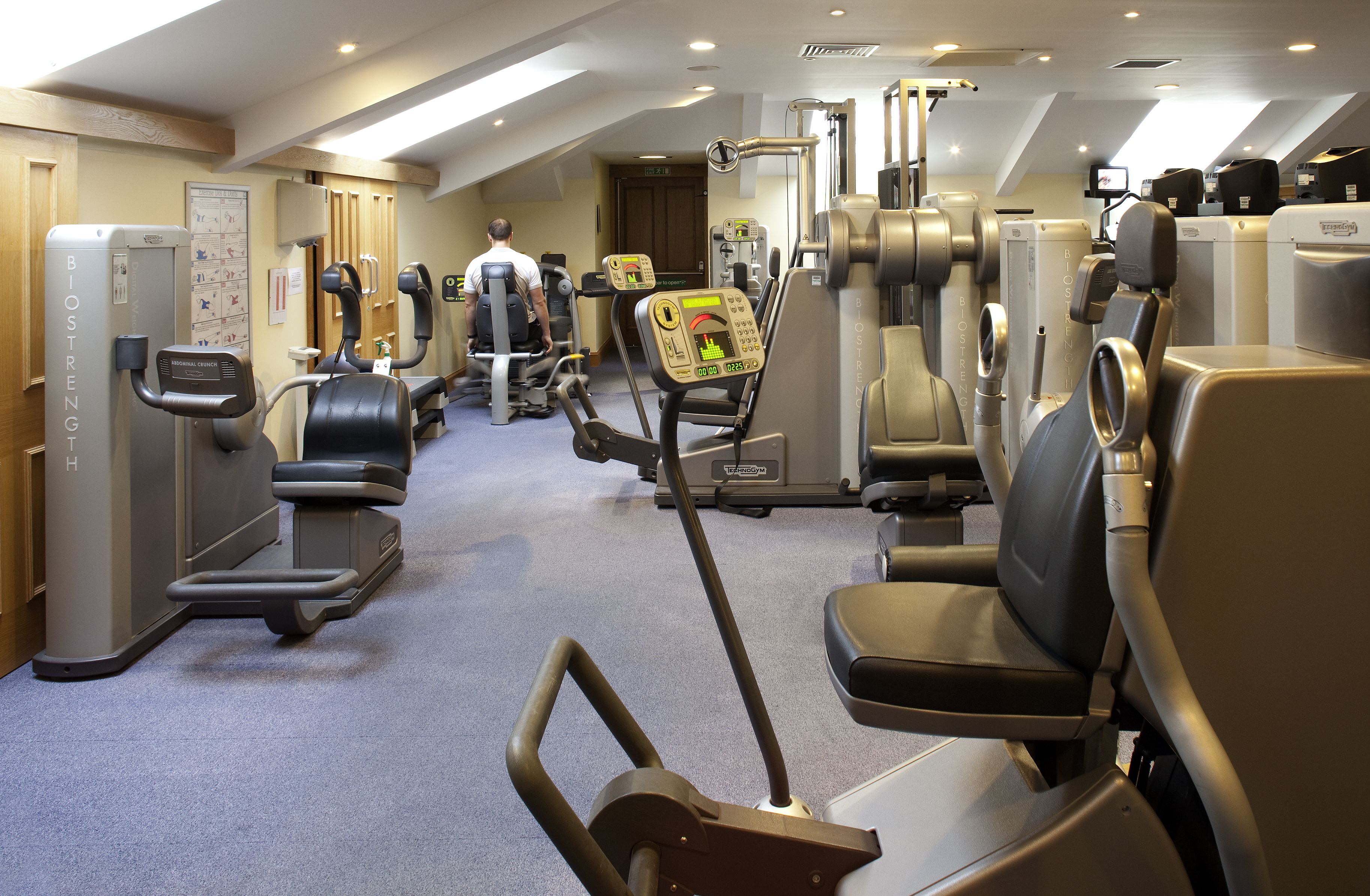 A gym with various exercise equipment, including treadmills and weight machines.