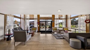 A spacious lobby with modern furniture, large windows, and a view of the outside. - Best Western Amador Inn (Jackson)
