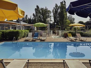 Seasonal outdoor pool, open 9:00 AM to 9:00 PM, pool umbrellas