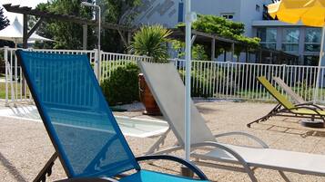 Seasonal outdoor pool, open 9:00 AM to 9:00 PM, pool umbrellas
