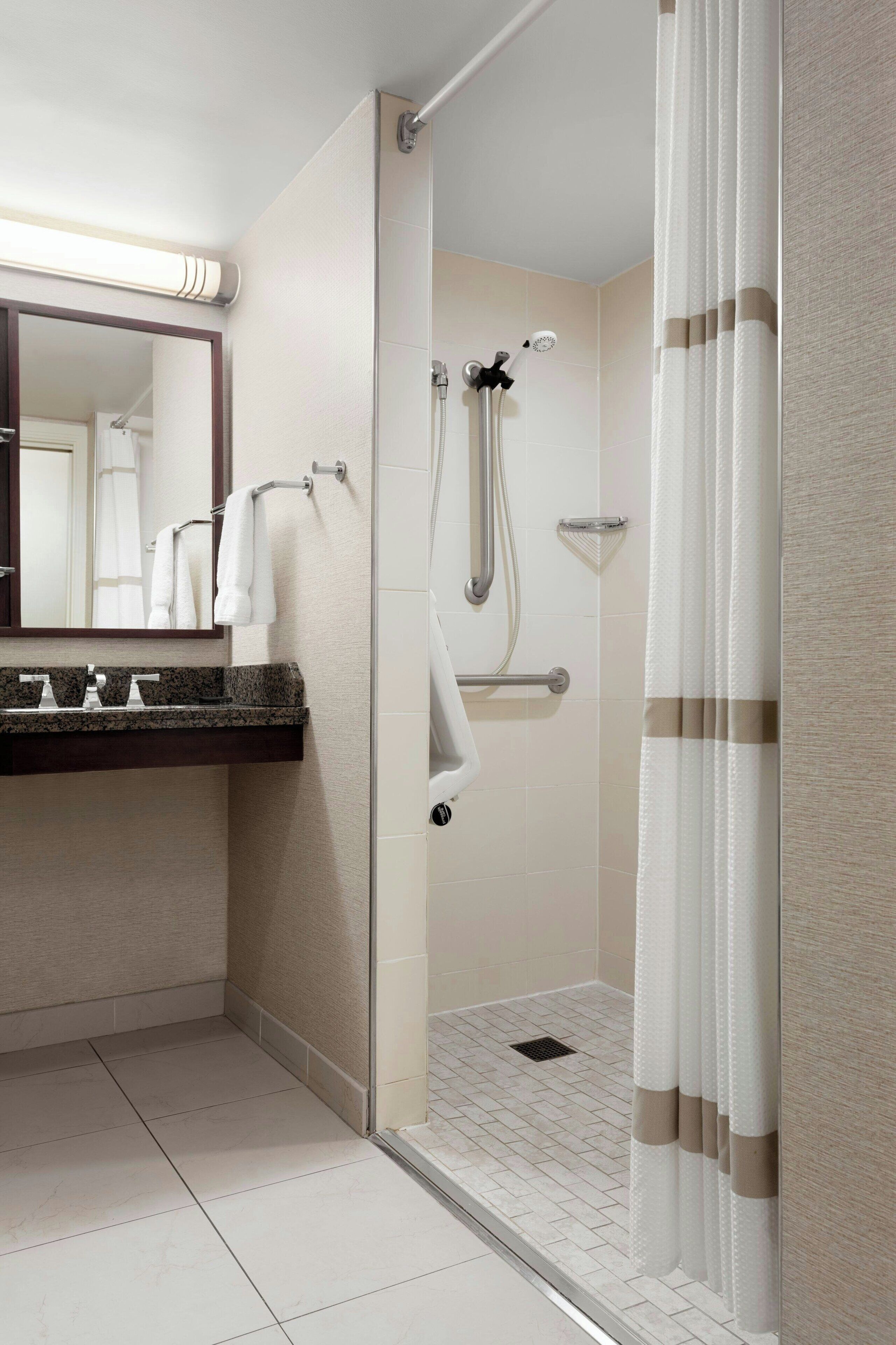room, 1 king bed (mobility accessible, roll-in shower) | bathroom | combined shower/bathtub, designer toiletries, hair dryer, towels