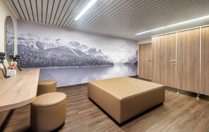 A modern bedroom with a large bed, a wooden desk, a mirror, and a mural of a lake and mountains. - Radisson Blu Hotel & Conference Centre, Salzburg (Salzburg)