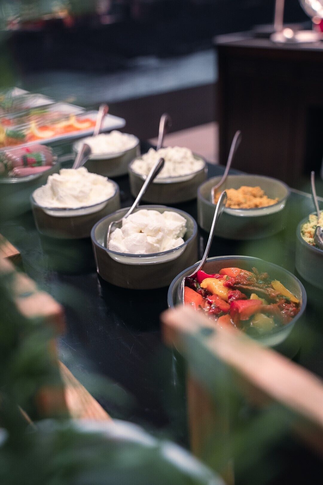 A buffet with various dishes including a bowl of soup and several bowls of what appears to be rice or a similar grain dish.