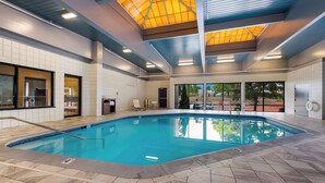 An indoor swimming pool with tiled walls and a ceiling with skylights. - Best Western Executive Hotel Of New Haven - West Haven (West Haven)