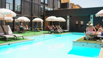 Seasonal outdoor pool, open 11:00 AM to 9:00 PM, pool umbrellas