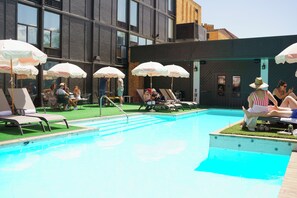 Seasonal outdoor pool, open 11:00 AM to 9:00 PM, pool umbrellas