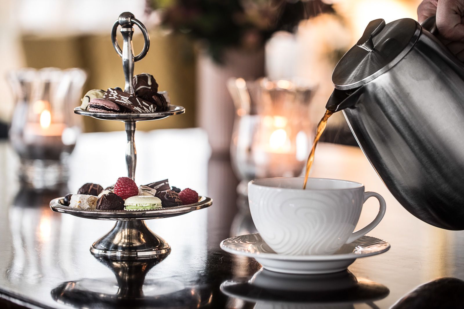 A tray of assorted desserts and a cup of coffee on a table.