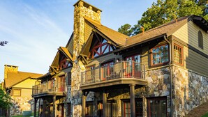 A stone building with multiple balconies and large windows. - Lanier Islands Resort (Buford)