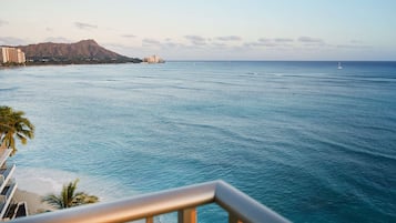 A coastal view with a mountain, ocean, and a building complex.