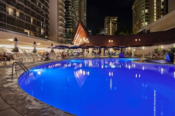 Outdoor pool, cabanas (surcharge), pool umbrellas at OUTRIGGER Reef Waikiki Beach Resort