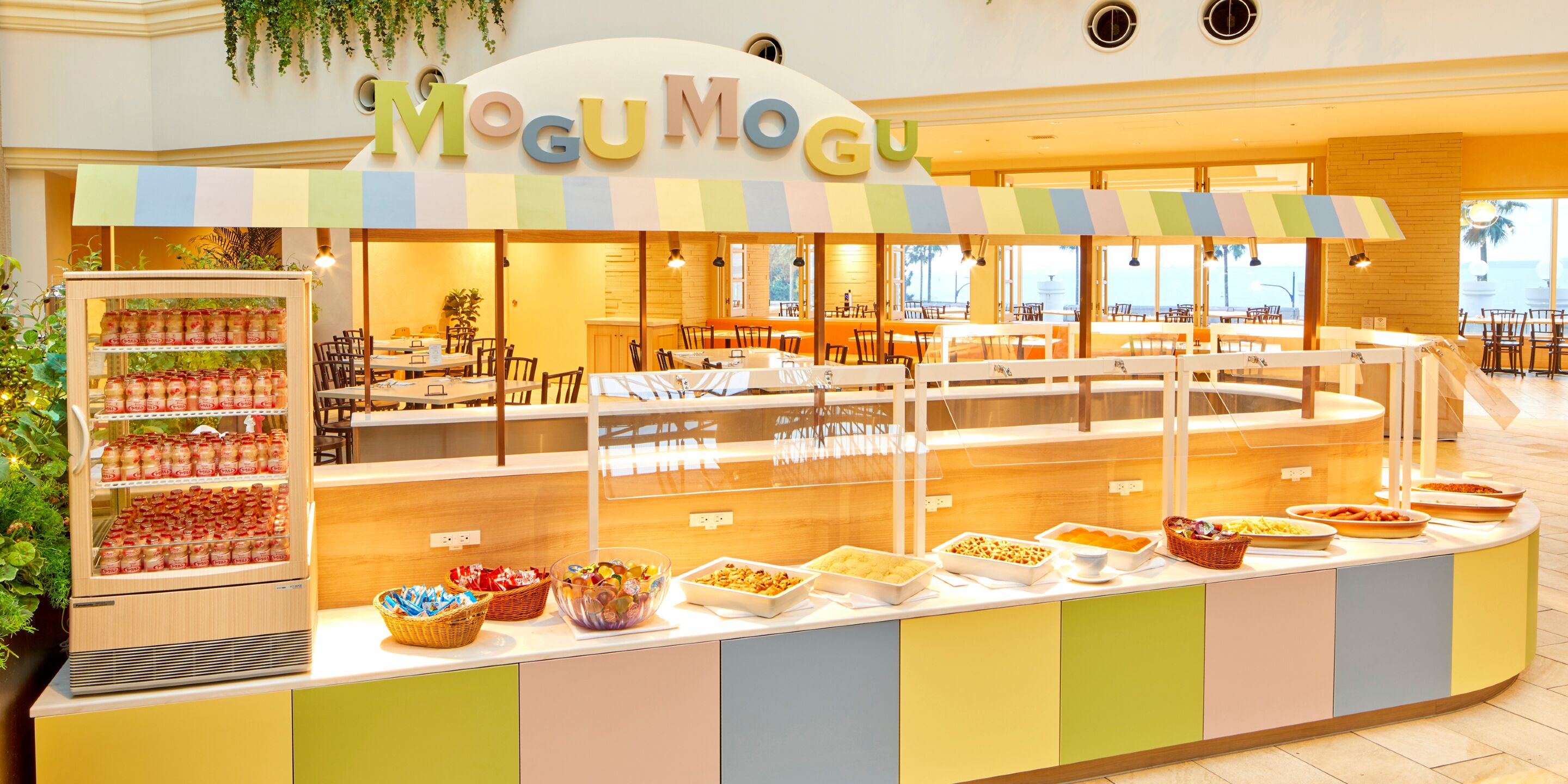 A buffet area with a variety of food items and a refrigerated display case.