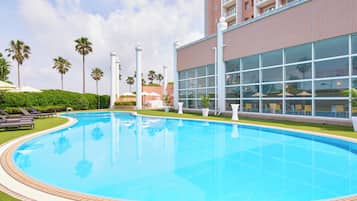 Indoor pool, seasonal outdoor pool, pool umbrellas, lifeguards on site