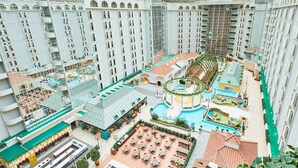 A high-rise hotel with multiple floors, a central courtyard with a pool, outdoor seating areas, and a variety of amenities. - Grand Nikko Tokyo Bay Maihama (Urayasu)