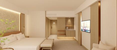 Una habitación de hotel moderna con una cama grande, zona de estar, televisión y kitchenette.