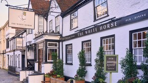 A traditional white building with a sign reading "The White Horse Pub, Dining Rooms" and a smaller sign for "The White Horse Garden." - The White Horse - A Heartwood Inn (Dorking)