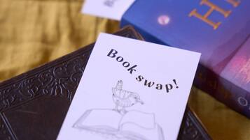 A book titled 'Victoria His' with a 'Book swap!' card on a textured surface.