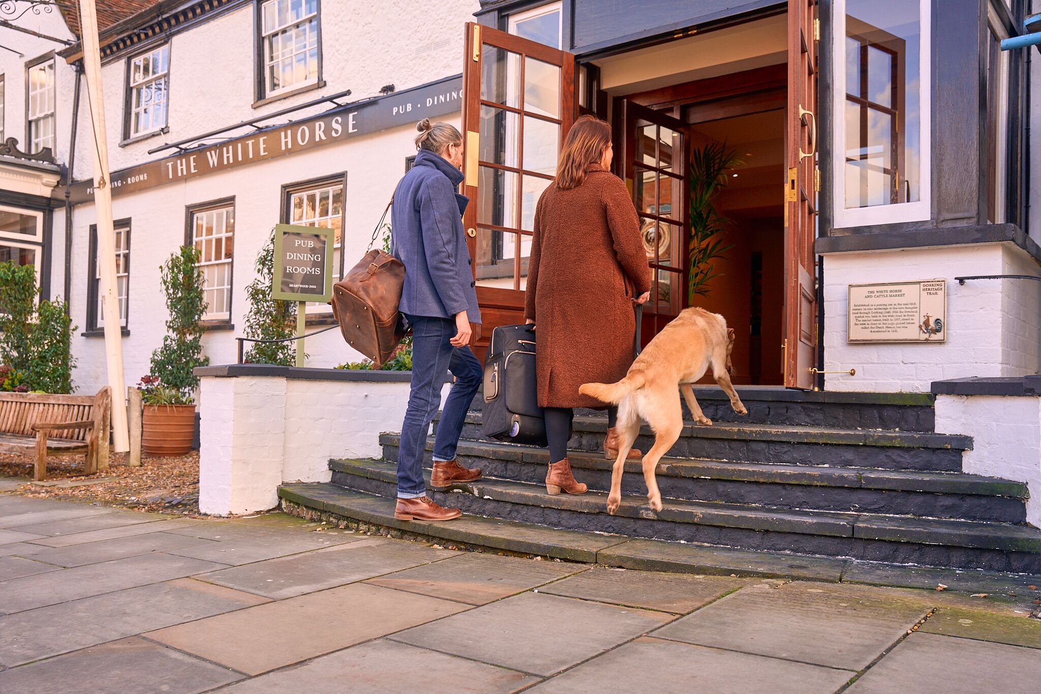 Un edificio con un letrero que dice "The White Horse Pub & Dining Rooms".