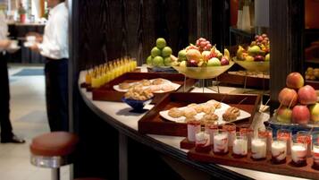A buffet with various food items and beverages.