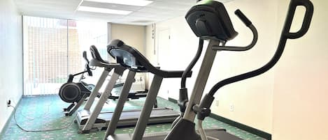 A gym with stationary bikes and treadmills.