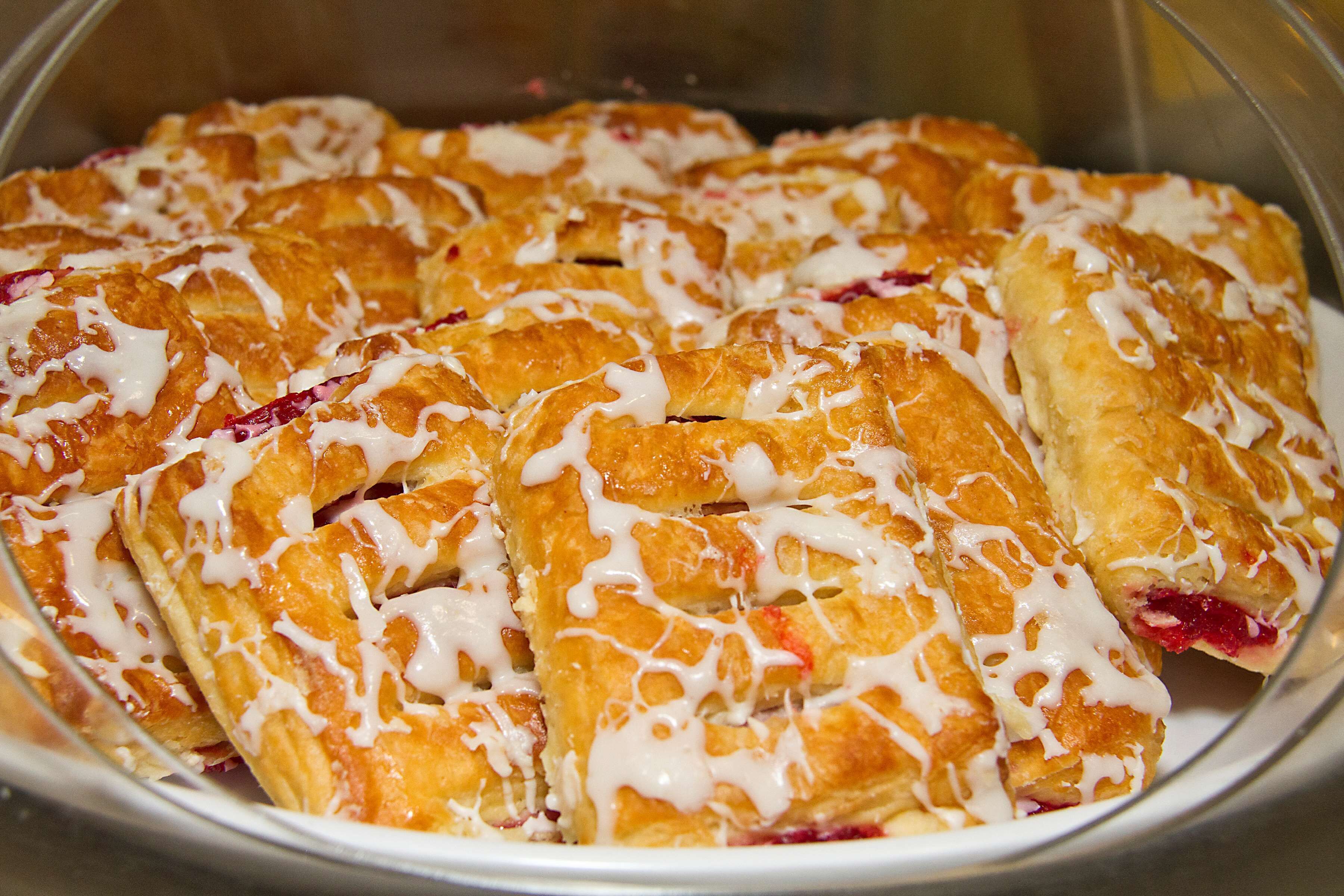 A tray of pastries with white icing.