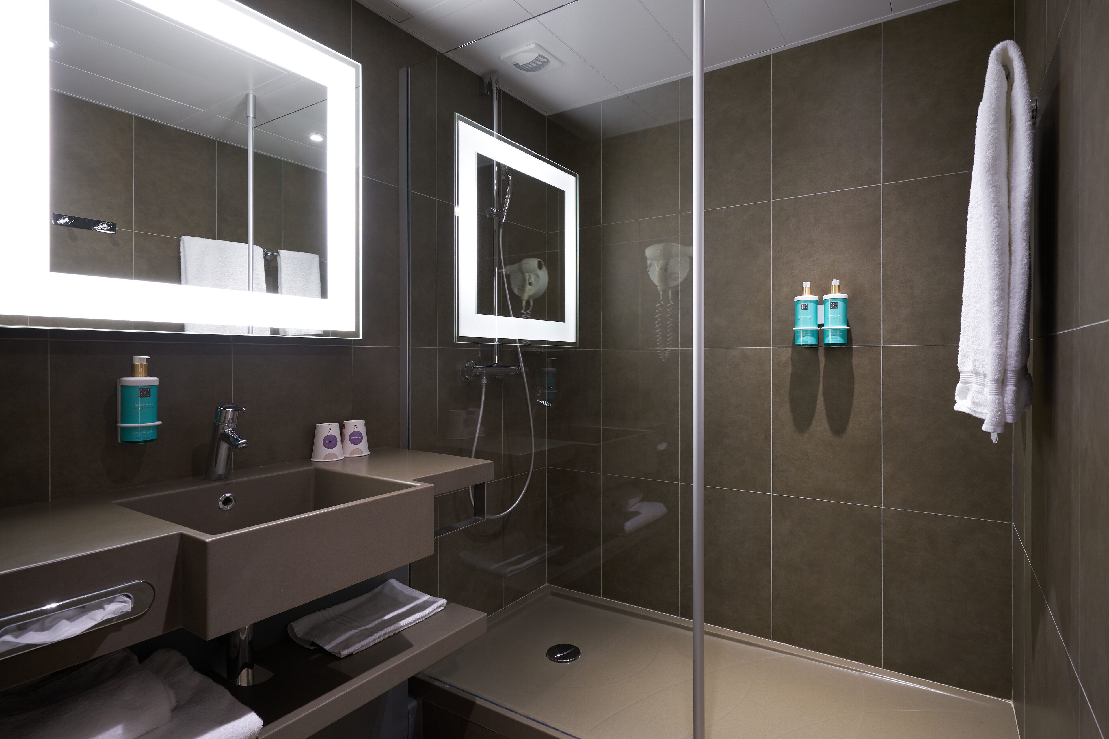 designer toiletries, hair dryer, towels, soap