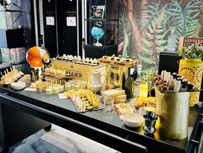 A buffet table with various food items and a champagne cooler labeled 'Champagne Allier.' - Novotel Marne Vallee Collegien (Collegien)