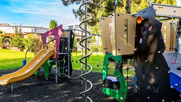 Kids can climb, slide, and play on the playground's equipment.