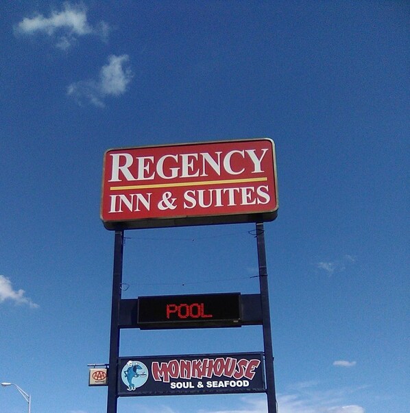 A sign for Regency Inn & Suites with a digital display below stating "POOL".