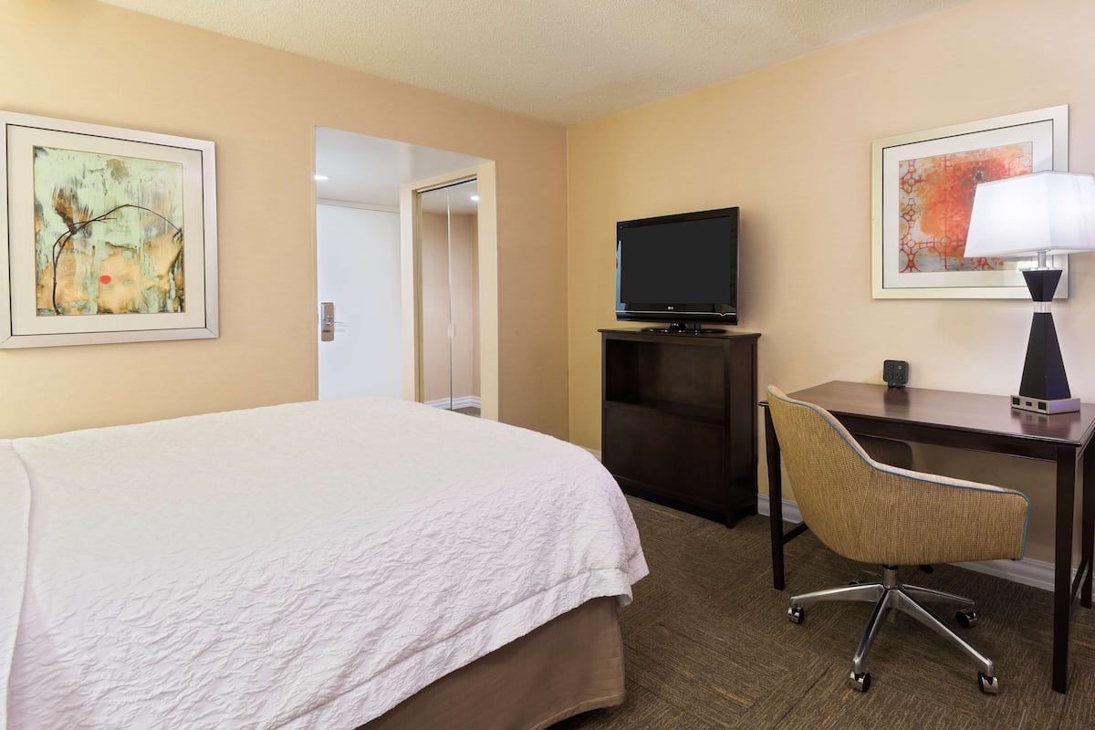 Desk, laptop workspace, blackout drapes, iron/ironing board