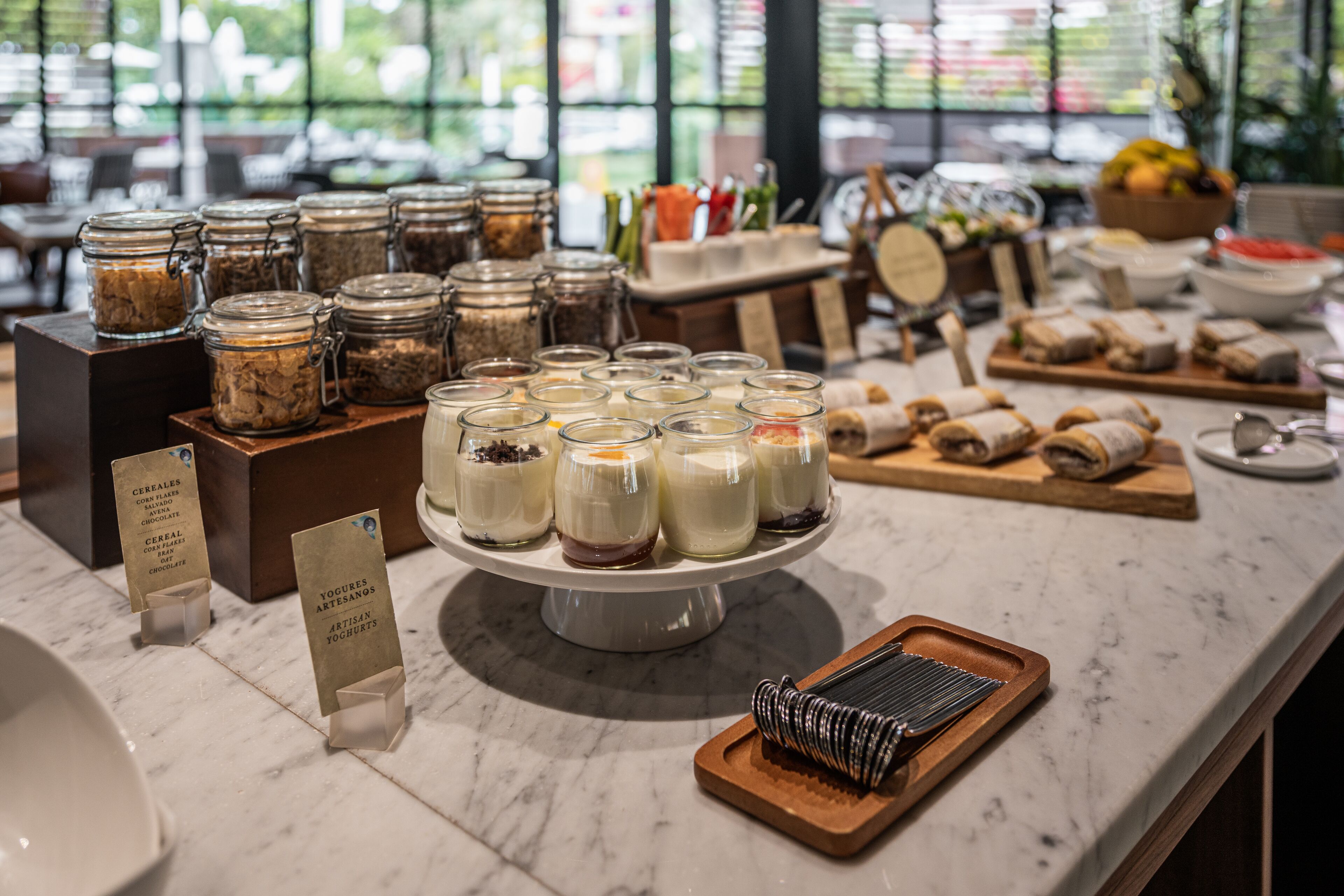 A buffet area with various food items and condiments.